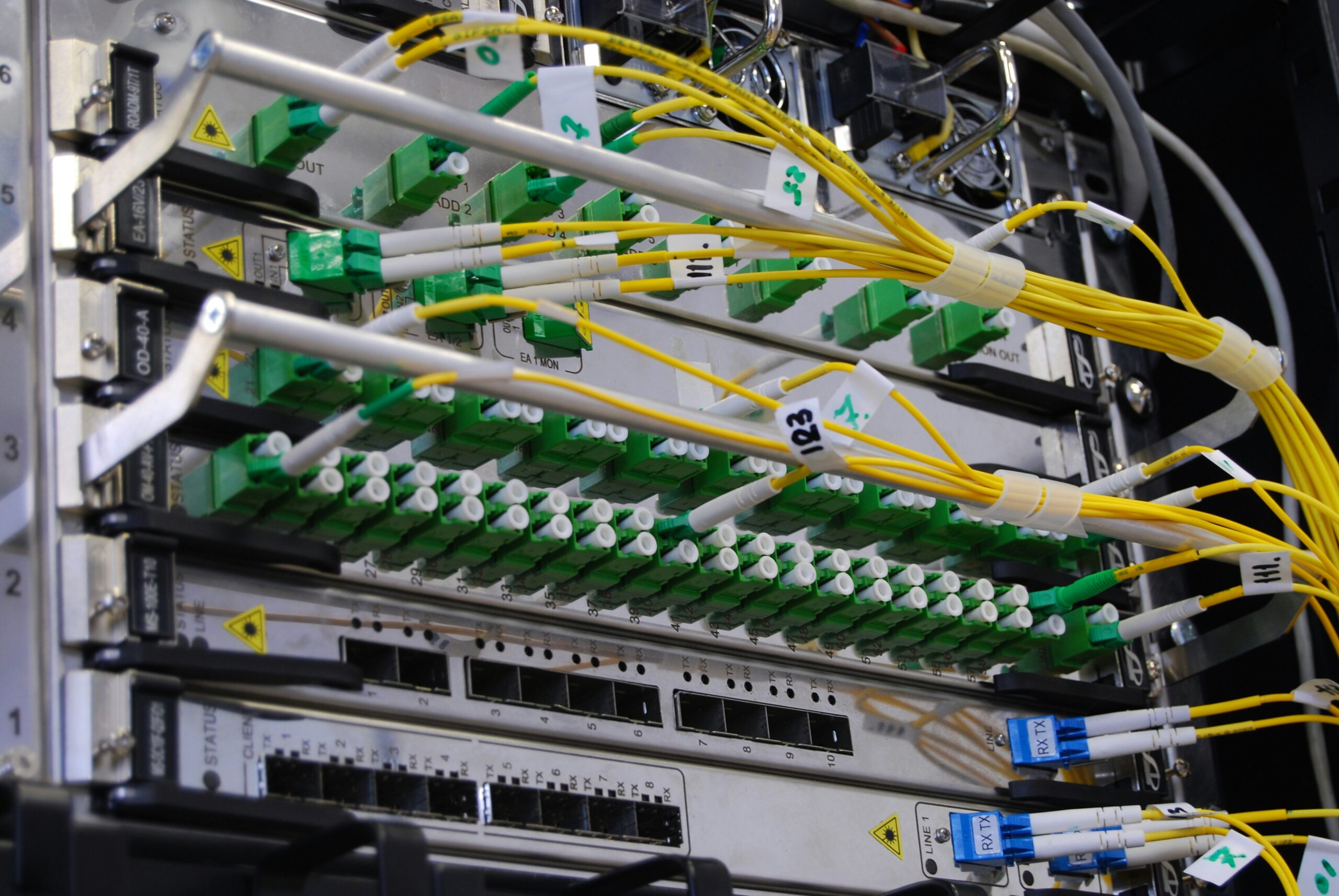 Fiber optic cables connected to a network switch in a server rack